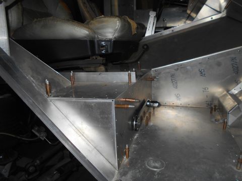 1992 Ford Bronco - The interior of a vehicle under construction shows custom aluminum fabrication around the driver's seat and center console area. Several co…