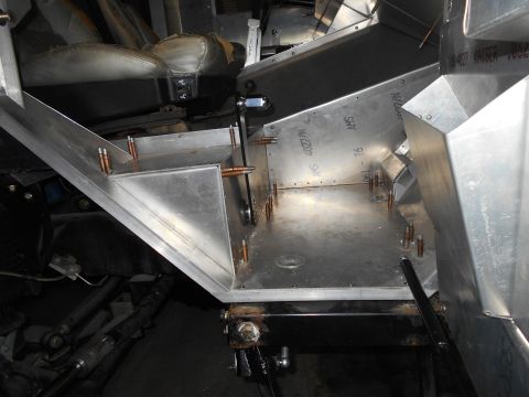 1992 Ford Bronco - A close-up view of the interior of a vehicle, showing custom aluminum fabrication and some of the original seating. The focus is on the con…