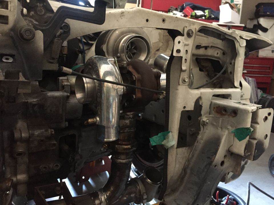 Custom turbocharger installation in a vehicle engine bay.