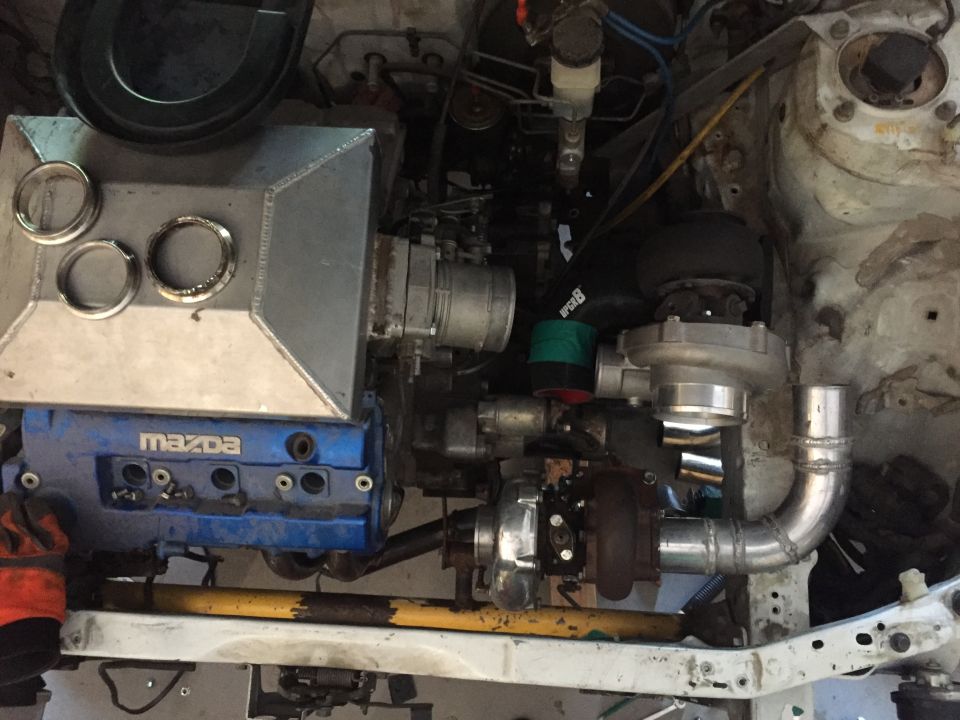 Modified Mazda engine with twin turbos and custom intake.