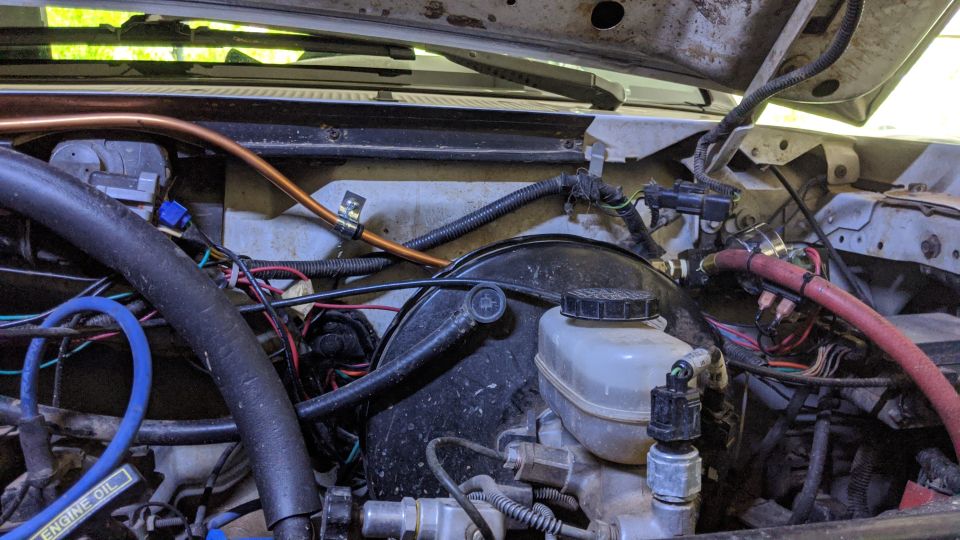 1995 Ford Bronco engine bay with brake fluid reservoir and wiring