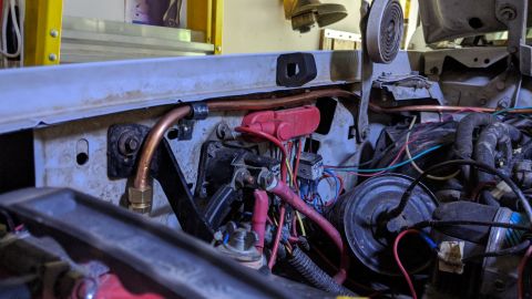 1995 Ford Bronco - Close-up view of the engine bay, showing various hoses and electrical components.