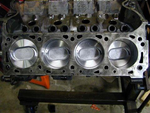 1979 Ford Bronco - Engine block with pistons installed, ready for further assembly or inspection.