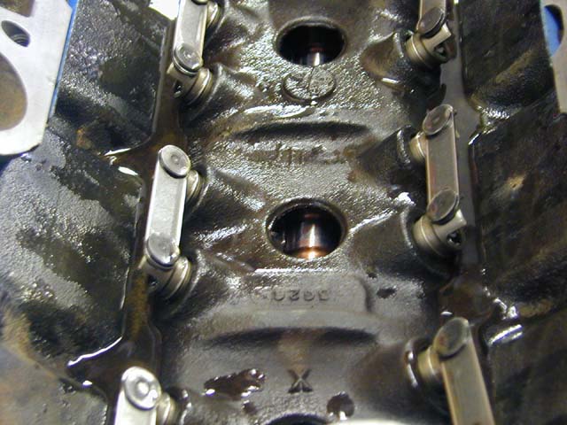 Close-up of engine cylinder head with rocker arms and oil