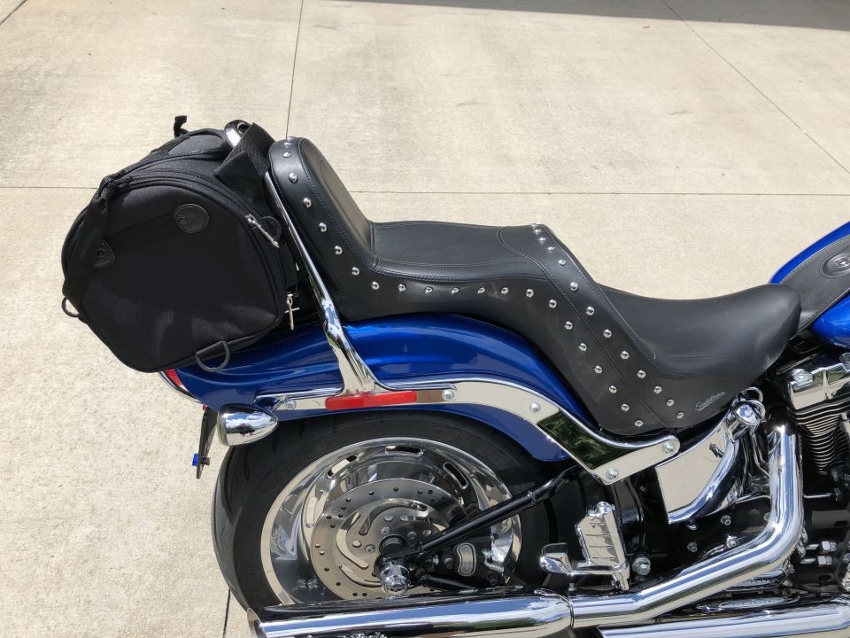 Blue Harley-Davidson motorcycle with black studded seat and saddlebag.