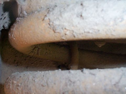 1979 Ford Bronco - Detail of a heavily soiled suspension coil retainer, likely from an older vehicle.