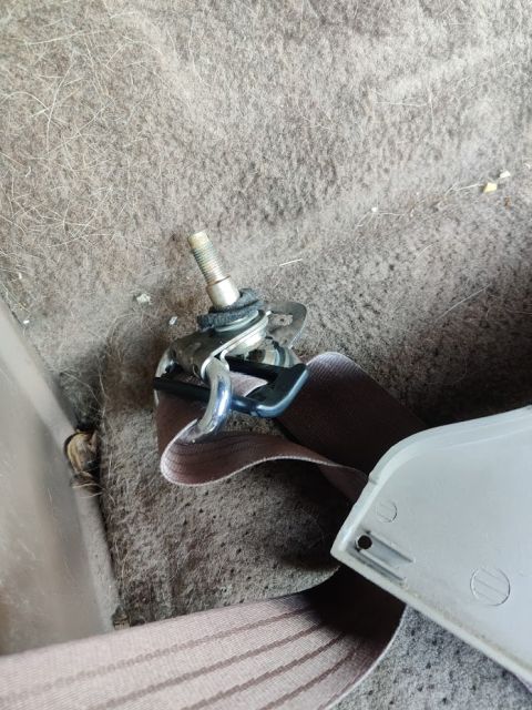 1996 Ford Bronco - 20200715 - Passenger seatbelt top bolt removed. It has some carpet-padding-like material between the bolt and the body of the truck it bolt…