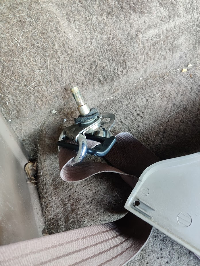 20200715 - Passenger seatbelt top bolt removed. It has some carpet-padding-like material between the bolt and the body of the truck it bolts to.