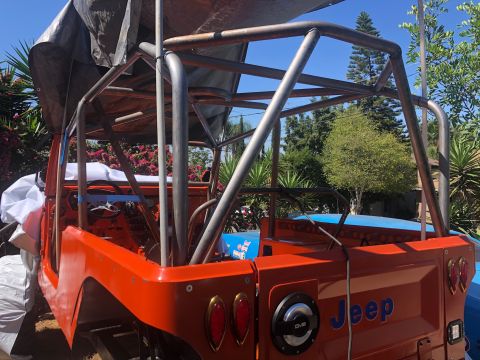 1992 Jeep Wrangler - This Jeep CJ-7 is undergoing modifications with a prominent custom roll cage structure.