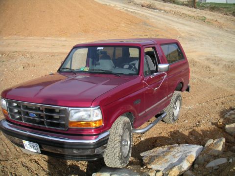 1994 Ford Bronco - This 1994 Ford Bronco is parked on a dirt lot with rocks scattered around.