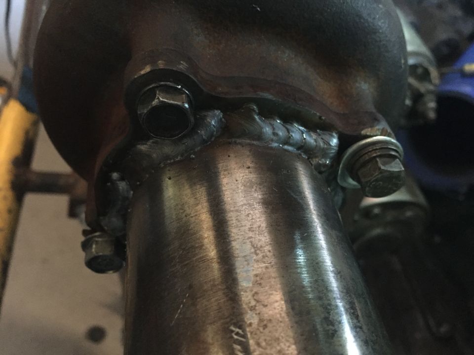 Exhaust pipe connection with hex bolts and visible welds