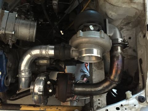 1993 Mercury Tracer - Custom twin turbocharger setup with polished aluminum piping and exhaust components.