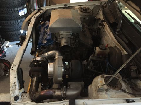 1993 Mercury Tracer - Custom turbocharger installation in a vehicle's engine bay, with visible exhaust piping and intake manifold.