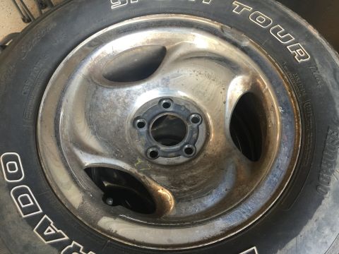 1998 Ford Ranger - A close-up view of a chrome wheel and tire, showing the 5-lug bolt pattern.
