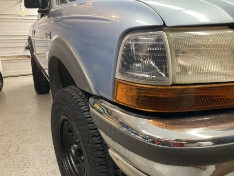 1998 Ford Ranger - Close-up view of the front passenger side of a 1998 Ford Ranger pickup truck.
