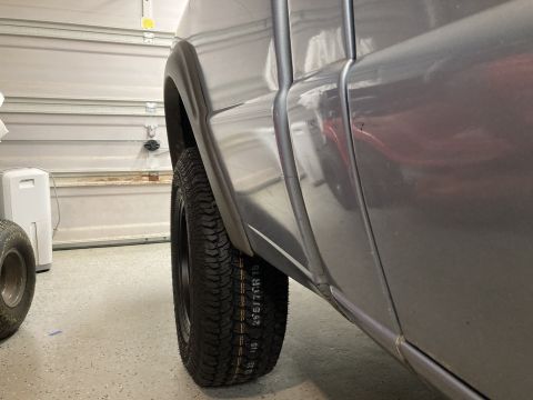 1998 Ford Ranger - Close-up of a gray truck's rear wheel and fender, showing tire size information.