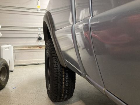 1998 Ford Ranger - Close-up view of a gray pickup truck's rear fender and tire, showing the tire size 265/70R16.