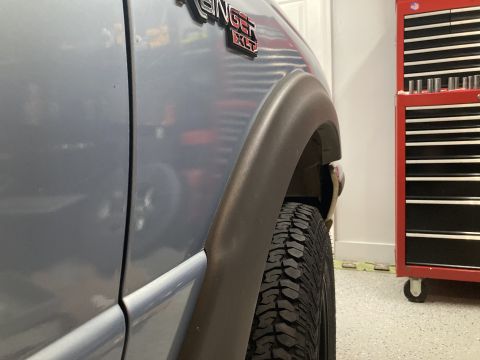 1998 Ford Ranger - Close-up of the fender flare and tire on a 1998 Ford Ranger XLT.