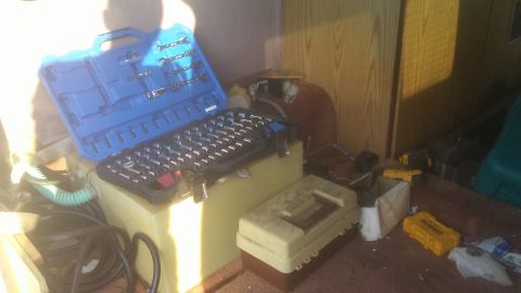 1988 Dodge RV/Conversion Chassis - Tools and storage containers are visible inside a cluttered space, possibly a vehicle's cargo area.