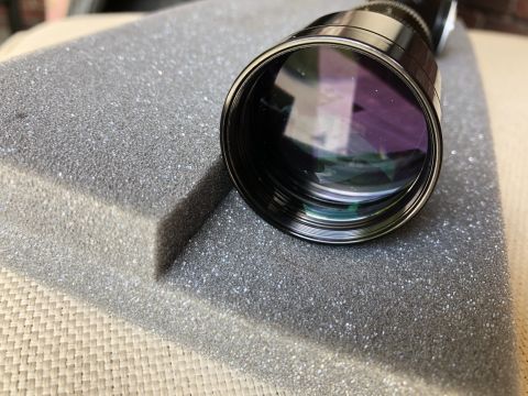 1995 Mercury Grand Marquis - Close-up of a telescope lens resting on protective foam, with a website logo visible.