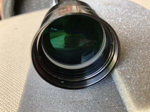 1995 Mercury Grand Marquis - A detailed view of an optical lens, showing its intricate threading and reflective green glass.