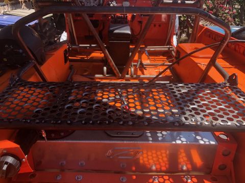 1992 Jeep Wrangler - Custom roll cage and interior modifications are visible in this orange off-road vehicle.