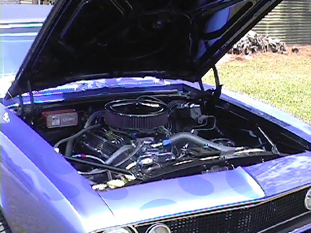 Purple 1967 Camaro engine bay with V8 and chrome open-element air cleaner, hood raised