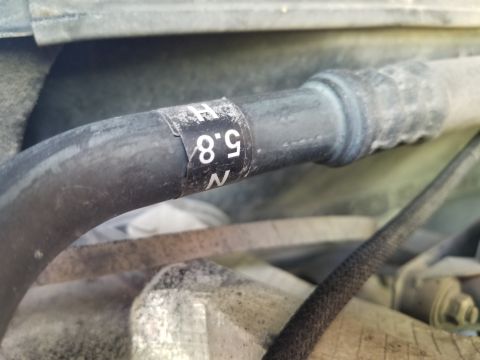 1996 Ford Bronco - A/C hose assembly label indicates compatibility with both smallblock V8s (5.0L N, 5.8L H)