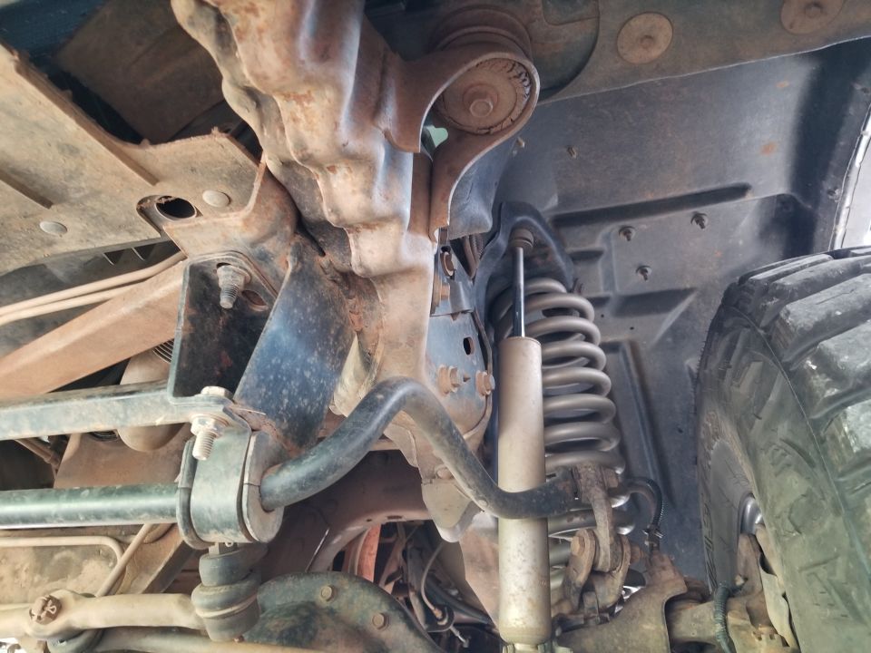 Underside view of vehicle suspension with shock absorber and coil spring