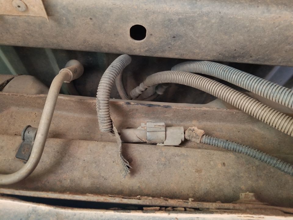 underbody fuel lines and wiring harness with a damaged protective sleeve