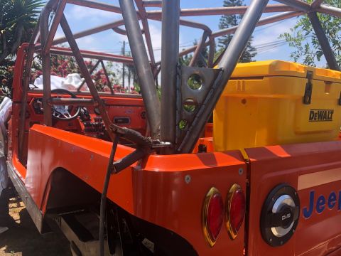 1992 Jeep Wrangler - Customized Jeep CJ-7 features a full roll cage and a yellow DeWalt cooler mounted in the rear.