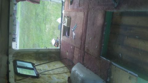 1988 Dodge RV/Conversion Chassis - Interior view of a vehicle, showing unfinished walls and a window with a view of a grassy field.