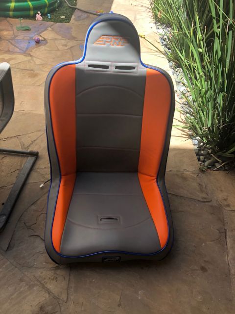 1992 Jeep Wrangler - A racing seat with gray and orange upholstery is shown outdoors on a stone patio.