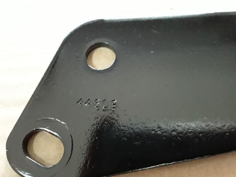1994 Ford Bronco - A close-up view of a black metal bracket with stamped identification numbers.