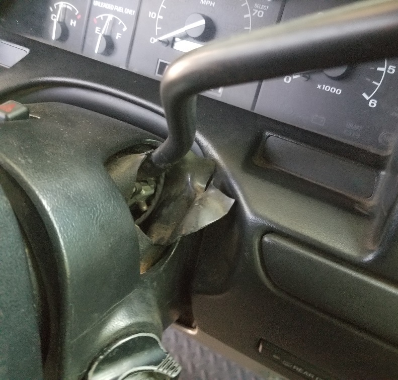 Damaged steering column ignition with exposed wires and tape