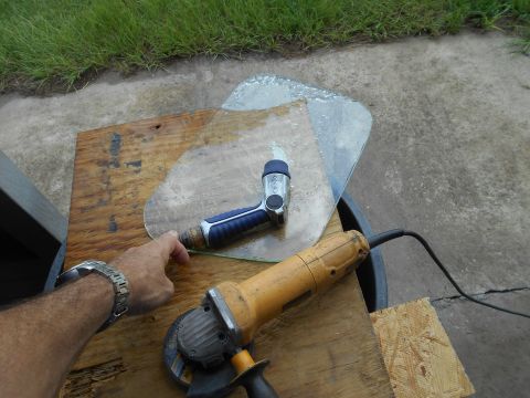 1992 Ford Bronco - Tools are laid out on a wooden surface, ready to cut a piece of glass.