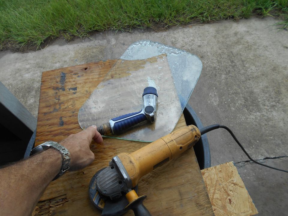 Angle grinder and glass cutter on a piece of glass