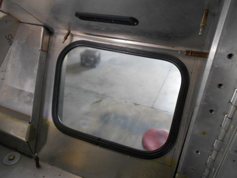 1992 Ford Bronco - Unfinished interior of a vehicle shows a window frame and metal paneling.