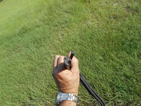 1992 Ford Bronco - A hand holds a black rubber seal against a grassy background. The Supermotors.net logo is visible in the lower right corner.