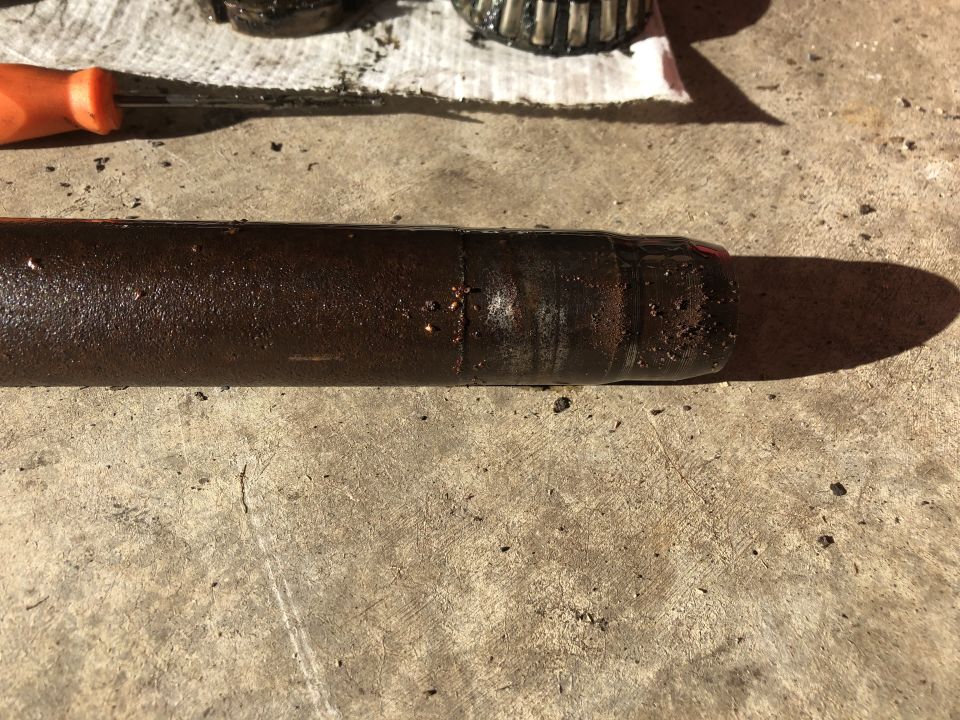 Drive shaft with grease and a bearing in the background