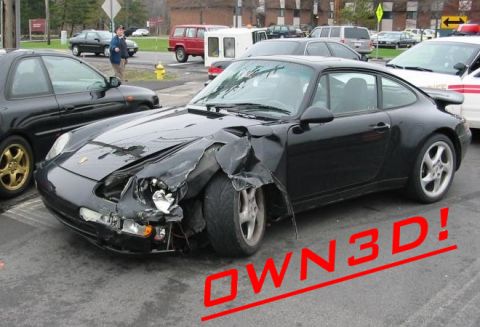2000 Ford Taurus - A black Porsche 911 sustained significant front-end damage, as indicated by the "OWN3D!" text overlay.