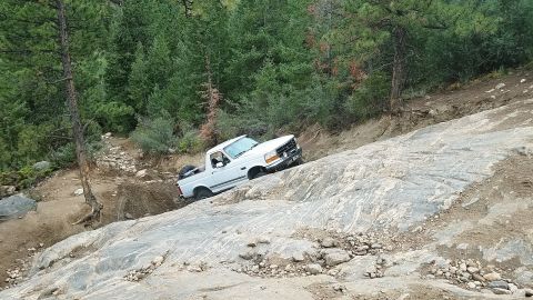 1995 Ford Bronco - White 1992 Ford Bronco tackles a challenging rocky off-road path.
