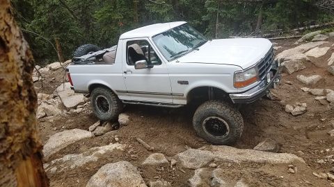 1995 Ford Bronco - This 1995 Ford Bronco is shown on a challenging, rocky off-road path.