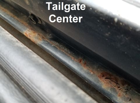 1996 Ford Bronco - The t/g is rusted much more-heavily near the center because of the missing outer weatherbelt allowing dirt to be washed off the window insi…