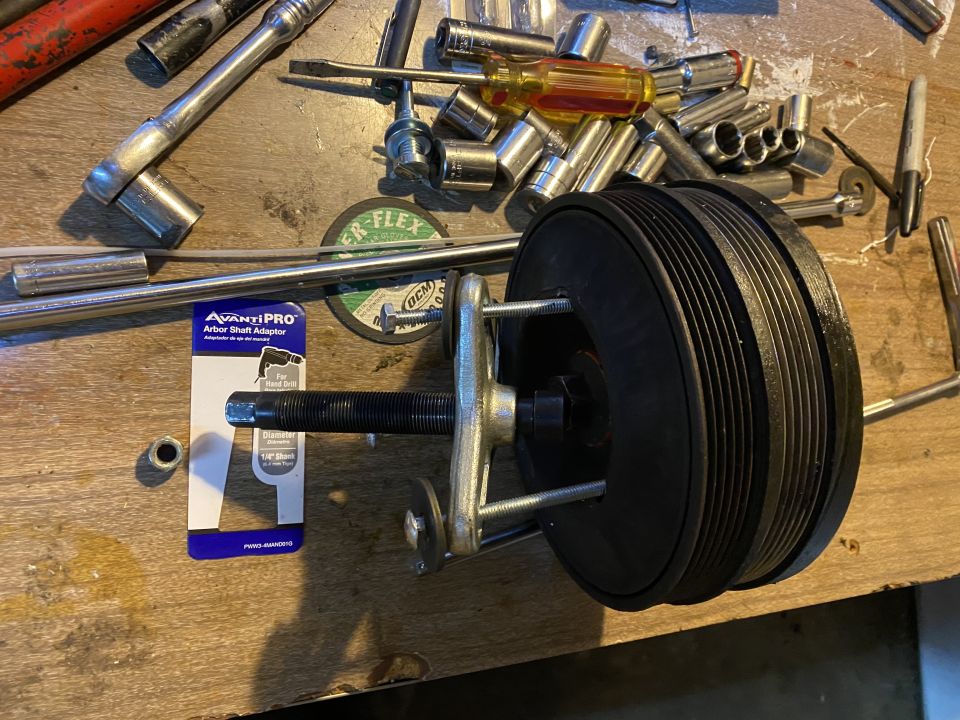 Pulley and Arbor Shaft Adapter with tools on a wooden surface