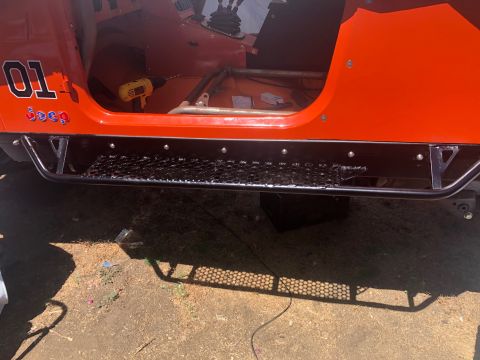 1992 Jeep Wrangler - Interior view of an orange 1992 Jeep Wrangler, custom decals and a drill on the floor.
