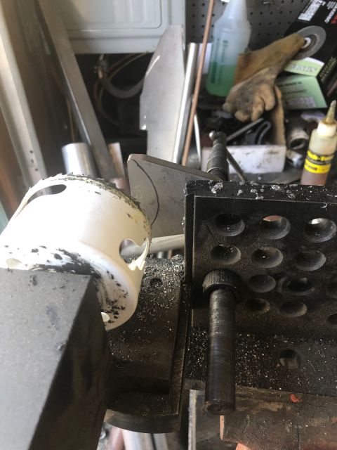1992 Jeep Wrangler - Machining a white plastic part in a vise, metal shavings are visible on the surface.