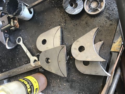 1992 Jeep Wrangler - Metal fabrication parts and tools are laid out on a workbench, ready for assembly or modification.