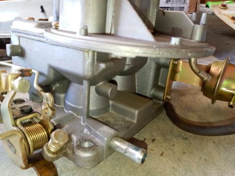 1994 Ford Bronco - Carburetor part shown in detail, with visible linkage and vacuum diaphragm.