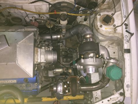 1993 Mercury Tracer - Custom engine build twin turbochargers and an intercooler, with visible Mazda branding.